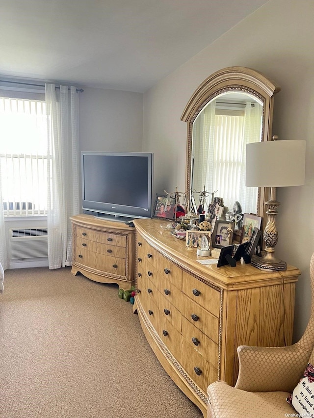 interior space with carpet flooring and a wall unit AC