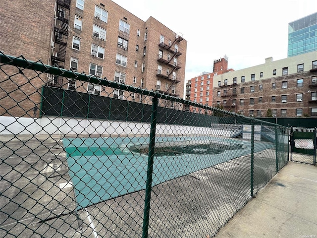 view of pool with tennis court