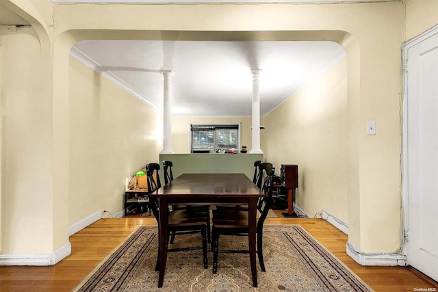 dining room with crown molding and hardwood / wood-style flooring