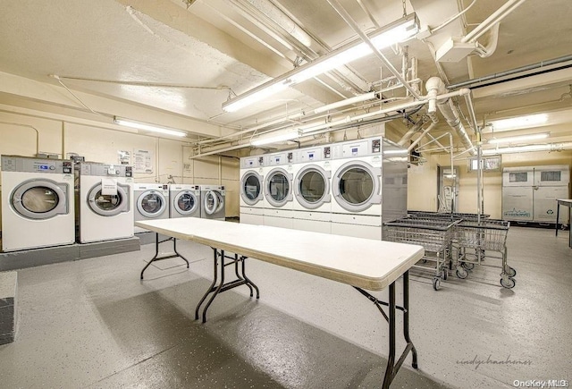 clothes washing area with separate washer and dryer