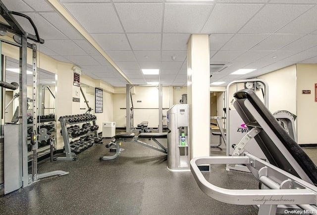 gym with a paneled ceiling