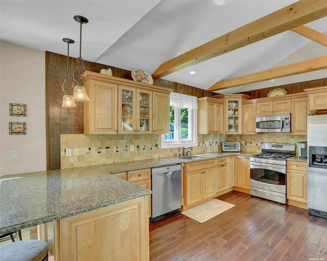 kitchen with kitchen peninsula, appliances with stainless steel finishes, decorative backsplash, pendant lighting, and vaulted ceiling with beams