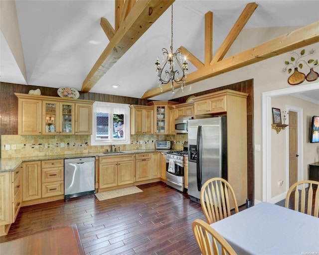 kitchen with light stone countertops, appliances with stainless steel finishes, decorative backsplash, dark wood-type flooring, and decorative light fixtures