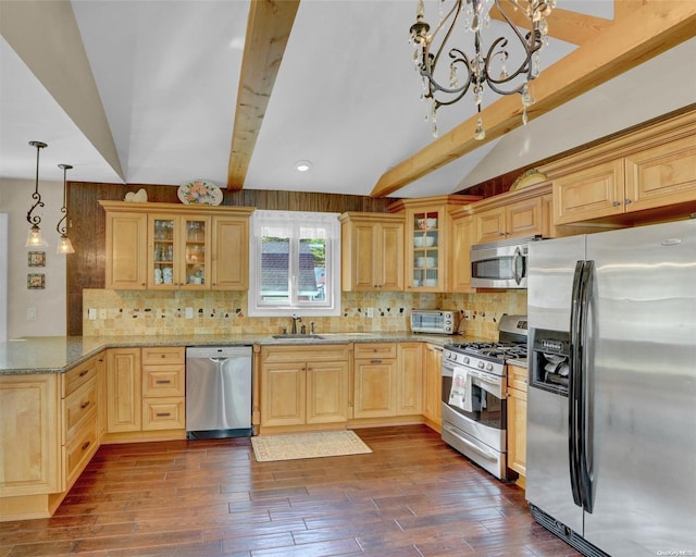 kitchen with sink, hanging light fixtures, light stone counters, dark hardwood / wood-style flooring, and stainless steel appliances