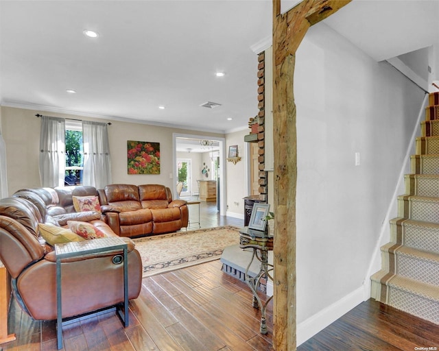 living room featuring hardwood / wood-style floors and crown molding