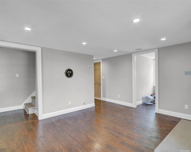 basement with dark hardwood / wood-style flooring