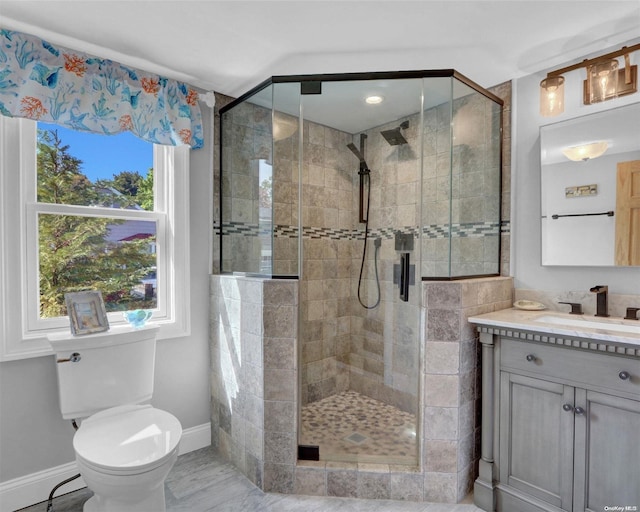 bathroom with vanity, an enclosed shower, and toilet