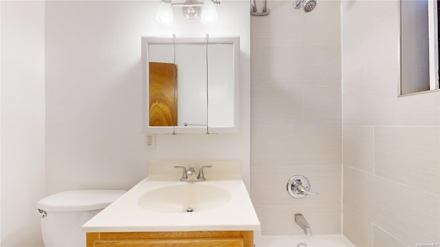 full bathroom with vanity, toilet, and tiled shower / bath combo