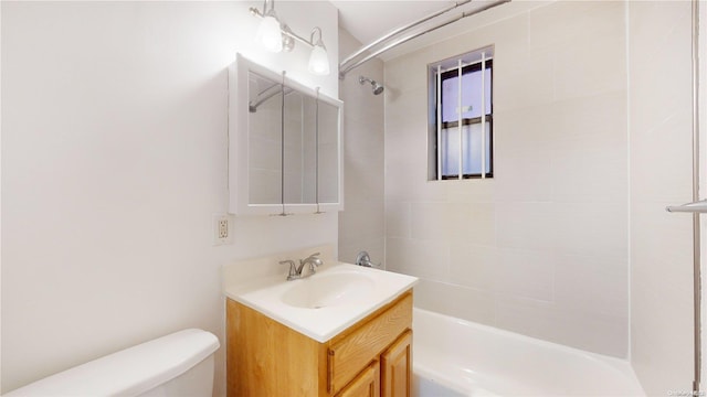 full bathroom with vanity, toilet, and tiled shower / bath combo