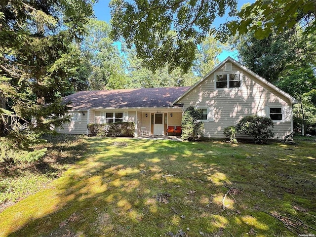 view of front of property with a front yard and a porch