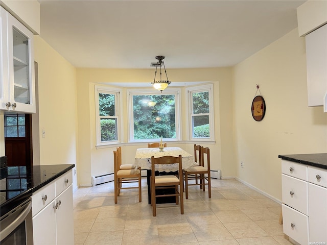 dining space featuring light tile patterned floors and a baseboard radiator