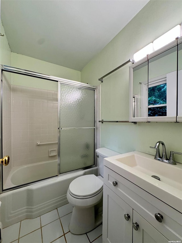 full bathroom with tile patterned floors, shower / bath combination with glass door, vanity, and toilet