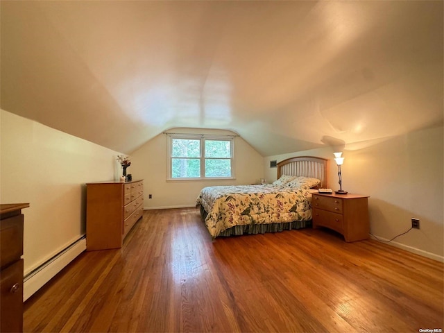 bedroom featuring hardwood / wood-style floors, baseboard heating, and vaulted ceiling