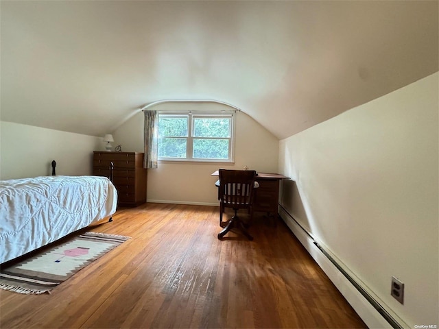 bedroom featuring light wood-type flooring, a baseboard radiator, and vaulted ceiling