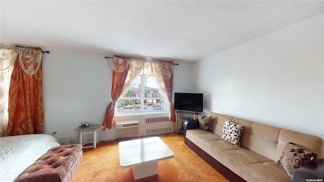 carpeted living room with a wall mounted air conditioner, radiator heating unit, and a textured ceiling