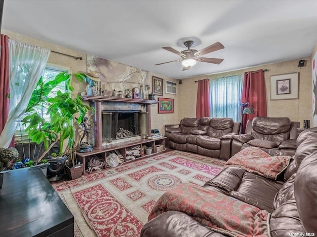 living room with a wall unit AC and ceiling fan