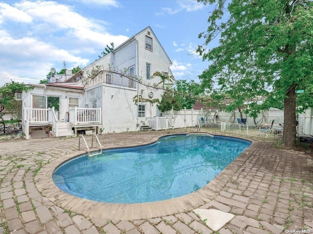 view of swimming pool with a patio area and a wooden deck