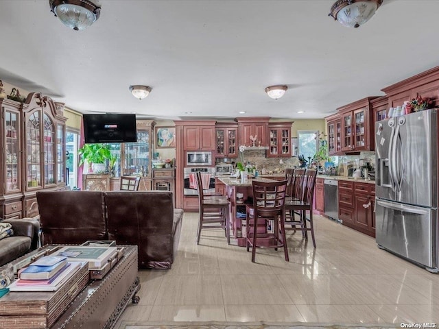 interior space with appliances with stainless steel finishes and backsplash