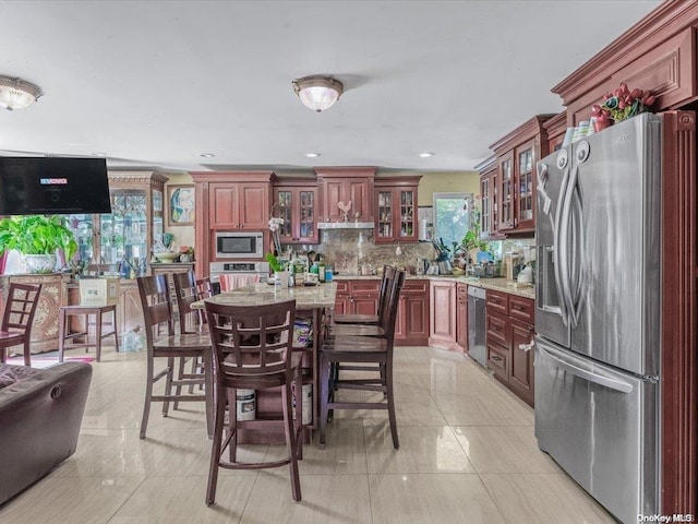 kitchen featuring tasteful backsplash, light tile patterned flooring, and stainless steel appliances