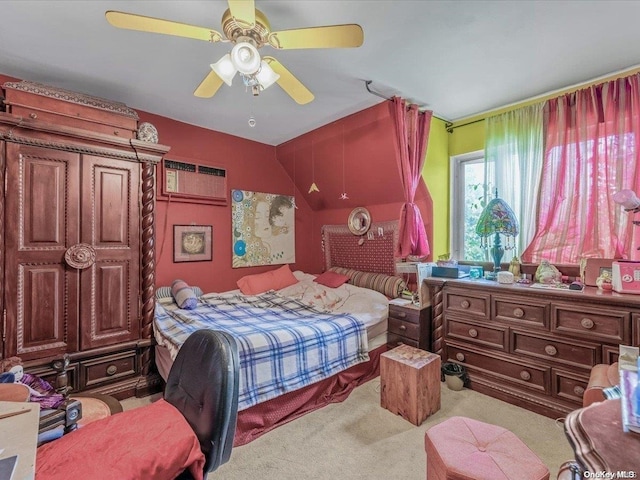 bedroom with an AC wall unit, ceiling fan, light colored carpet, and vaulted ceiling