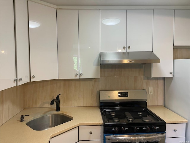 kitchen featuring white cabinets, sink, and stainless steel range with gas stovetop