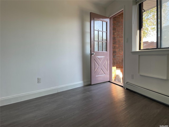 foyer with a baseboard radiator and dark hardwood / wood-style floors