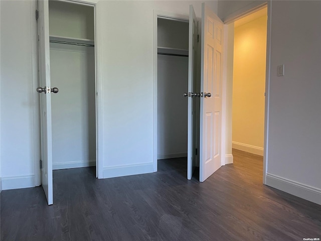 unfurnished bedroom featuring dark wood-type flooring