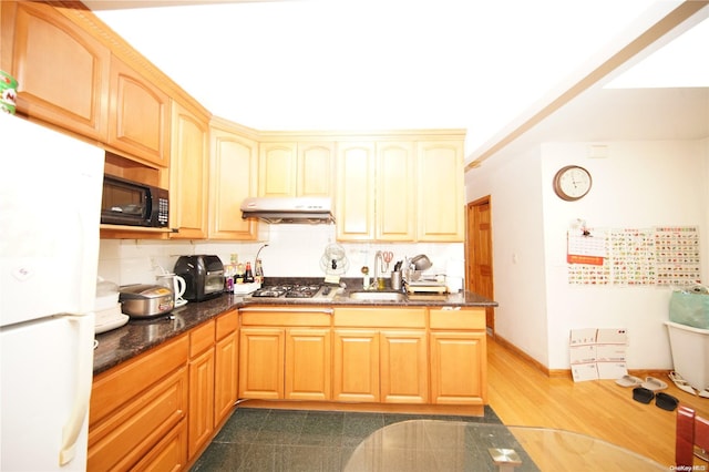 kitchen with sink, dark hardwood / wood-style floors, tasteful backsplash, white fridge, and stainless steel gas cooktop