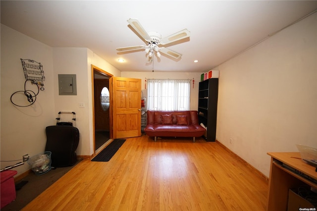 unfurnished room with ceiling fan, light wood-type flooring, and electric panel