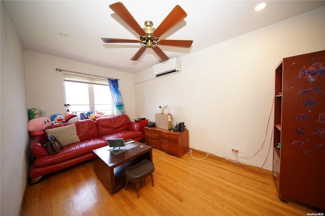 living room featuring ceiling fan, wood-type flooring, and a wall mounted AC