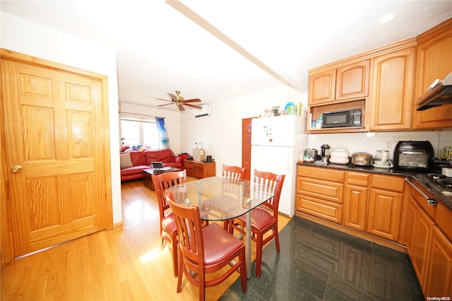 kitchen featuring tasteful backsplash, ceiling fan, light hardwood / wood-style floors, and white refrigerator