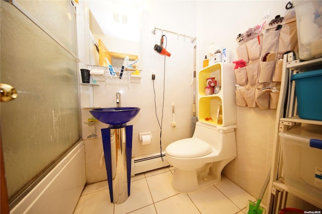 full bathroom with sink, a baseboard radiator, tile patterned flooring, toilet, and tile walls