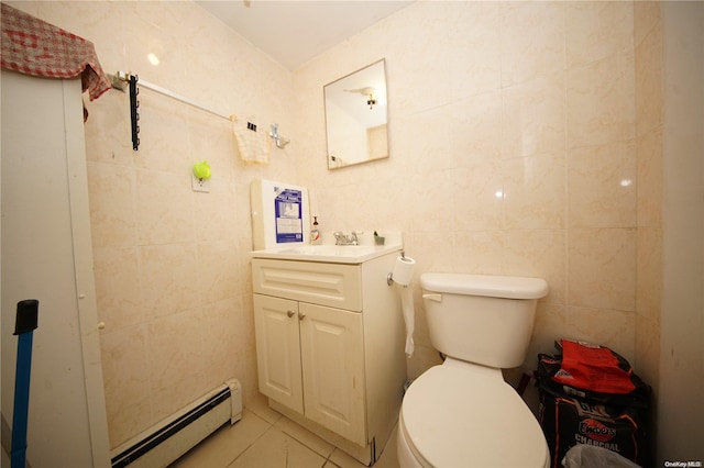 bathroom with tile patterned floors, vanity, tile walls, and a baseboard heating unit