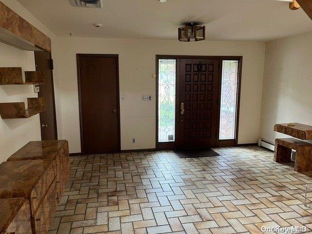 foyer entrance featuring a baseboard radiator