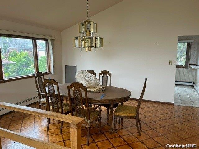 dining area featuring plenty of natural light, lofted ceiling, and a chandelier