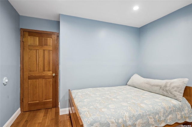 bedroom with hardwood / wood-style floors