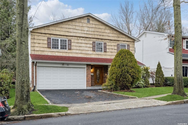 view of front property with a front yard and a garage