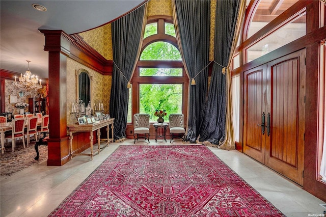 tiled entrance foyer with a notable chandelier