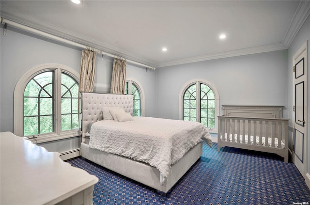 bedroom with dark colored carpet, a baseboard heating unit, multiple windows, and crown molding