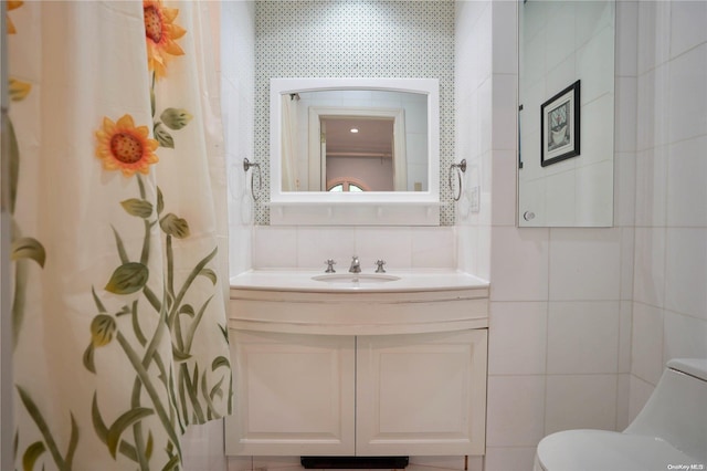 bathroom featuring backsplash, walk in shower, vanity, tile walls, and toilet