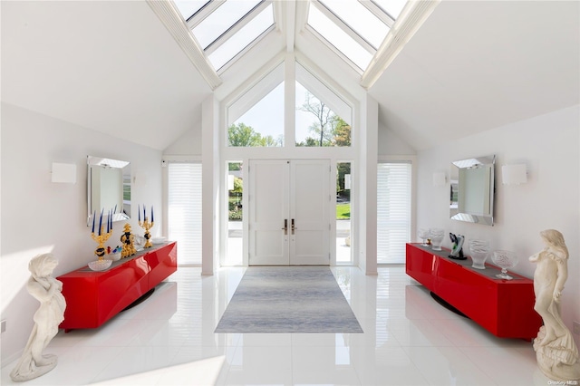 entryway featuring light tile patterned floors and high vaulted ceiling