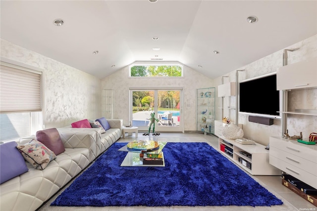 living room featuring light tile patterned floors and vaulted ceiling