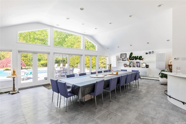 dining space with high vaulted ceiling and a baseboard heating unit