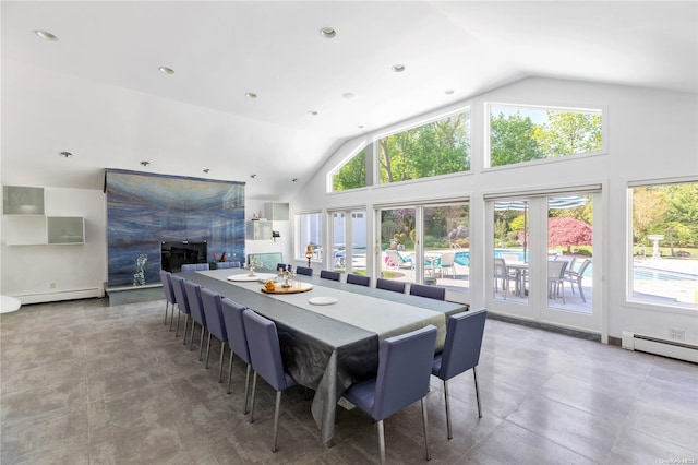 dining area featuring baseboard heating and high vaulted ceiling