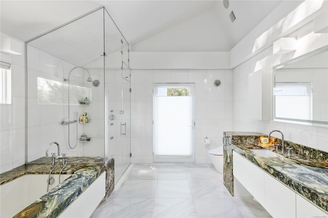 full bathroom with vanity, tile walls, plus walk in shower, toilet, and lofted ceiling