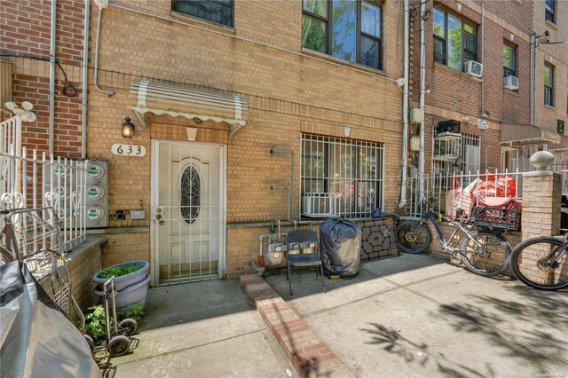 entrance to property featuring cooling unit