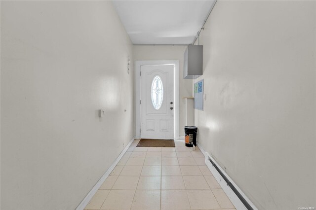 doorway to outside with light tile patterned floors