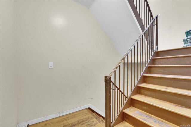 staircase with wood-type flooring