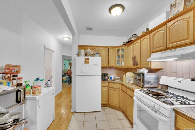 kitchen featuring tasteful backsplash, white appliances, and light wood-type flooring