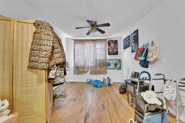 interior space featuring wood-type flooring and ceiling fan